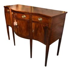 an antique sideboard with two drawers and brass pulls on the front, against a white background