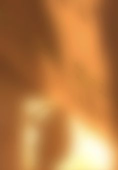 blurry image of an orange and brown background with some light on the left side