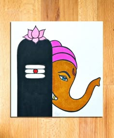 an elephant with a pink turban on its head is next to a black object