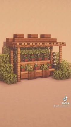 a small building made out of wood and plants on the outside, sitting in front of a wall