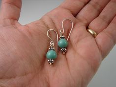 Casual handmade earrings made with 8mm round Aqua/Turquoise color imitation pearls and sterling silver beads dangling from handmade sterling silver ear wires. Measurments: Length: 1 3/8 inches from top of earwire Turquoise Earrings With Silver Round Beads, Turquoise Sterling Silver Hypoallergenic Beaded Earrings, Hypoallergenic Turquoise Beaded Earrings In Sterling Silver, Turquoise Sterling Silver Earrings With Silver Beads, Turquoise Beaded Earrings With Silver Beads As Gift, Earrings Casual, Long Silver Earrings, Infinity Earrings, Casual Earrings