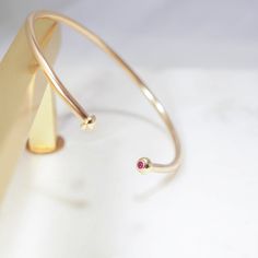 Rubied cuff - each Ruby stone is set delicately in a tapered round 14kt setting. She is adjustable, a heavier cuff then our Sloane, Opal, Garnet & Jade. 14/20 gold filled - 2.4mm wire 14kt Setting 2 - 2mm AA Ruby 6.5" Ruby Stone, Natural Earth, Garnet, Gold Filled, Necklace Lengths, Jade, Ruby, Opal, Bangles