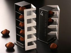 some chocolates are sitting in a box on a black table and one is empty