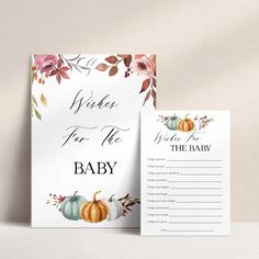 a white card with flowers and pumpkins on it, next to an envelope that says guess the baby food