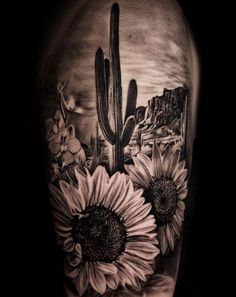 a black and white photo of a cactus with sunflowers