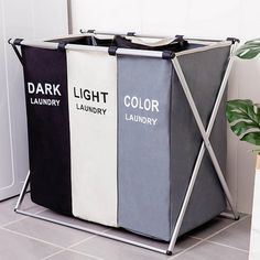 three laundry hampers sitting next to each other on the floor