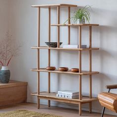 a living room with a chair and book shelf