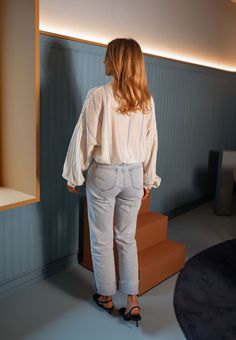 Pale-light yellow long sleeve collared shirt that features chic blue stripes while offering a flowy-comfortable fit. The perfect versatile and classy shirt that you can style up or down no matter the season or occasion. Our model also wears the Light Blue Maddie Jeans. Sizes: S-M / M-L S-M: Length 23.23 in - Width 22.44 in M-L: Length 24.41 in - Width 23.23 in 86% Rayon - 12% Polyester - 2% Nylon Washing: handwash only Spring Striped Relaxed Fit Blouse, Long Sleeve Blouse With Striped Collar For Day Out, Chic Long Sleeve Blouse With Striped Collar, Chic Blouse With Striped Collar For Day Out, Spring Oversized Blouse With Striped Collar, Chic Light Wash Top For Daywear, Oversized Blouse With Striped Collar For Spring, Spring Daywear Blouse With Striped Collar, Chic Spring Blouse With Striped Collar