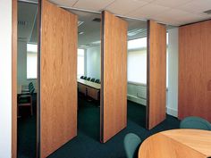 an office cubicle with wooden partitions and chairs