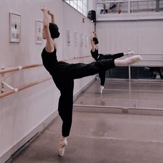 a person doing a hand stand in a dance studio