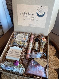 an open gift box containing soaps, candles and other items