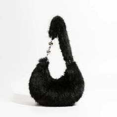 Discover Your New Favorite Accessory Step into a world of style and comfort with our Chic Fuzzy Faux Fur Half Moon Shoulder Bag. Designed for the modern woman who values both fashion and functionality, this trendy plush crossbody purse is a must-have addition to your accessory collection. Whether you're running errands, heading to a brunch, or enjoying a night out, this bag complements every occasion with its versatile design. Exceptional Features This shoulder bag showcases a unique half-moon s Moon Shoulder Bag, Faux Fur Material, Moon Shapes, Minimalist Interior, Crossbody Purse, Half Moon, Soft Textures, Modern Woman, Running Errands