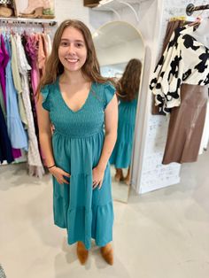 You have just found THE PERFECT dress for Fall with our Fall Dress to Impress Smocked Maxi Dress! With a V neckline, flutter mini sleeves, and a smocked bodice, this dress flatters every figure. The tiered midi skirt is lined and has a medium weight, making it perfect for any occasion. And don't forget - it has pockets! Trust us, this teal dress is not one to miss. Available in sizes small to 3X. The Deets: Fit: True to size Material: 100% Polyester Brand: Blu Pepper Measurements: 45" long, 13" Maternity Maxi Dress With Smocked Bodice, Blue Fitted V-neck Smocked Dress, Fall V-neck Smocked Dress, Blue V-neck Smocked Dress, Bohemian Blue Smocked Midi-length Dress, Razorback Shirt, Tiered Midi Skirt, Teal Dress, Plus Size Pants