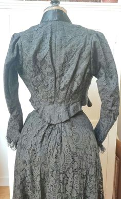 Perfect unworn condition ! Edwardian matching skirt and blouse, black mechanic lace featuring a large floral pattern, the skirt is complete with the heavy and thick satin underskirt, hooks fastening to back, pocket, featuring two beautiful linings to sleeves and bust, complete hooks fastening to front, lace addition to wrists and floral ribbons to sleeves and bust, soft boning.  Condition: very good unworn condition with two pulled threads that should be easy to fix, hooks are rusty and should b Formal Fitted Lace Sets, Elegant Fitted Victorian Dress With Lace Work, Fitted Vintage Set With Lace Trim, Formal Victorian Dress With Lace Collar, Fitted Vintage Sets With Lace Trim, Fitted Lace Victorian Dress For Daywear, Fitted Lace Trim Sets For Daywear, Elegant Black Lace Sets, Formal Fitted Victorian Dress With Lace Collar