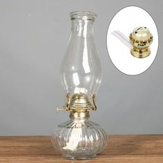 an old fashioned glass oil lamp on a wooden table