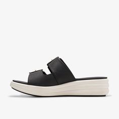 WOMENS Drift Buckle Black Wedges | Clarks US Casual Slip-on Wedge Sandals With Buckle, Spring Buckle Closure Slip-on Sport Sandals, Spring Slip-on Footbed Sandals With Buckle Closure, Slip-on Wedge Sandals With Buckle Closure For Beach, Black Buckle Closure Slip-on Sandals, Casual Dress Shoes, Trending Sandals, Black Wedges, Platform Slippers