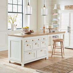 a kitchen island with two stools in front of it and an open floor plan