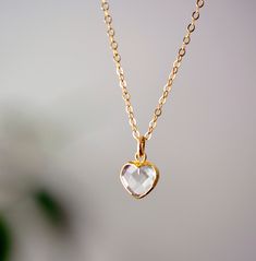 "Clear Crystal Quartz Heart Necklace - 14k Gold Filled Looking for a unique accessory to show off your self love, or love for that special someone? Crafted from 14k gold filled and natural clear quartz, this pedant is the perfect, sparkling way to show anyone your love.  Crystal Quartz, also called Rock Crystal, is considered the ultimate healing stone. It balances and revitalizes the mental, physical, spiritual, and emotional aspects of the body. Also, it's believed to amplify the energy or int White 14k Gold Heart Necklace For Gift, 14k Gold White Heart Necklace For Gift, Delicate Open Heart Jewelry For Anniversary Gift, Delicate Heart Cut Jewelry Gift, Delicate Heart Cut Jewelry For Gift, Dainty Heart-shaped Jewelry For Anniversary Gift, Delicate Heart-shaped Jewelry For Anniversary, Delicate Heart-shaped Jewelry For Anniversary Gift, Minimalist Heart Shaped Diamond Cut Jewelry