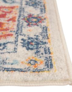 an area rug with various colors and designs on the floor, including blue, yellow, orange