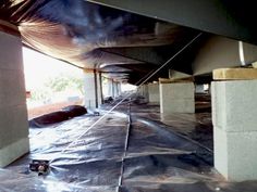 the inside of an office building covered in tarp and duct tape, under construction