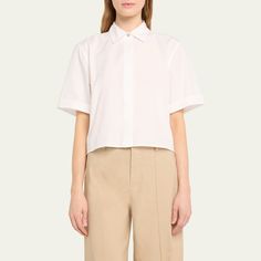 Vince crop shirt punctuated by mother-of-pearl buttons Approx. 22.1”L from shoulder to hem Spread collar; hidden button placket Short sleeves Yoked back Hip length Boxy fit Cotton Imported Classic Short Sleeve Cropped Shirt For Work, Classic Cropped Short Sleeve Shirt For Work, Elegant Cropped Cotton Shirt, Modern Collared Cropped Shirt For Work, Classic Cropped Shirt For Summer Workwear, Classic White Cropped Shirt For Daywear, Modern Short Sleeve Tops With Button Cuffs, Fitted Cropped Blouse With Button Cuffs, Classic Cropped Shirt For Office