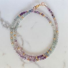 "This beautiful necklace is handcrafted with an array of glittering fluorite gemstones, each unique and rich in natural character.  D E T A I L S » High quality AAA grade fluorite  » Faceted 3mm round beads » 14K gold filled lobster clasp and components  » Length: 17\"  » 100% genuine, natural gemstones » Handmade in NY G I F T I N G  Arrives thoughtfully packaged in an eco-friendly kraft box wrapped with ribbon, ready for gifting or treasuring for yourself. Also includes care instructions and storage bag to keep your item looking beautiful. Please read shop policies for the fine print...thanks for browsing my Etsy shop!" Purple Fluorite Round Bead Jewelry, Purple Fluorite Gemstone Beaded Jewelry, Double Strand Amethyst Gemstone Beads Jewelry, Purple Fluorite Gemstone Bead Jewelry, Spiritual Fluorite Gemstone Beads Jewelry, Fluorite Gemstone Bead Necklace For Gift, Fluorite Gemstone Beads Necklace As Gift, Fluorite Gemstone Beads Necklace For Gifts, Gemstone Choker Necklace