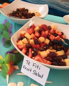 fruit salad served in white bowls on a blue table