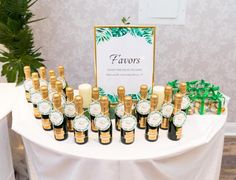 a table topped with lots of bottles of liquor next to a sign that says favors