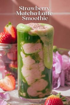 strawberry matcha latte smoothie in a jar with strawberries on the side