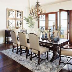 a dining room table with chairs and a chandelier