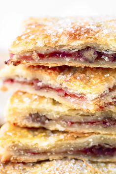 a stack of strawberry shortcakes with powdered sugar on top