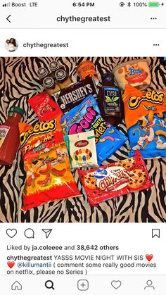 a bunch of candy on top of a zebra print blanket with the caption crythegreates