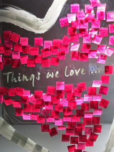 a bulletin board with pink sticky notes attached to it and the words thing we love written on it