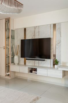 a flat screen tv sitting on top of a white entertainment center