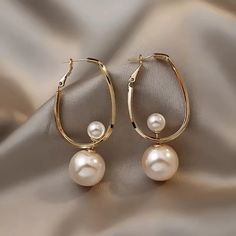 Enhance your style with these elegant Pearl Of Wisdom Hoop Earrings. These earrings feature a beautiful pearl that represents wisdom, adding a touch of sophistication to any outfit. Made with quality materials, these earrings are a must-have accessory for any fashion-forward individual. Discover the perfect blend of simplicity and sophistication with A Pearl Of Wisdom Hoop Earrings. Pearl White Hoop Pearl Earrings, Pearl White Pearl Hoop Earrings, Elegant Pearl Hoop Earrings With Ear Wire, Trendy Hoop Earrings With Pearl Drop, Trendy Pearl Hoop Earrings, Your Style, Fashion Forward, Hoop Earrings