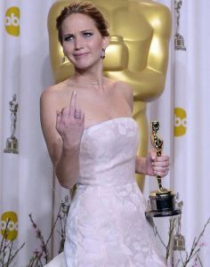 a woman in a white dress holding an award for her role in the film,