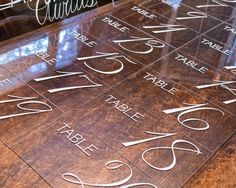 a wooden table topped with lots of different types of writing on it's sides