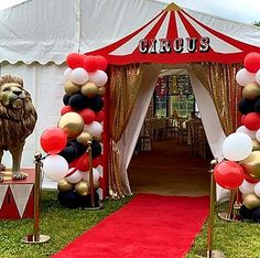 a circus tent decorated with balloons and lions