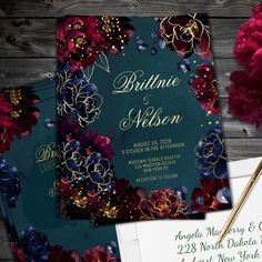 the wedding stationery is decorated with flowers and gold foil lettering, along with two envelopes