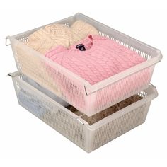 two plastic baskets with clothes in them on top of each other, one holding a pink sweater and the other white