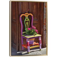 a colorful painted chair with flowers in the pot