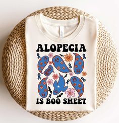 an alopecia is boosh t - shirt sitting on a wicker basket