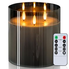 a lit candle with remote controls in front of it