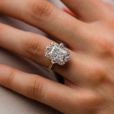 a woman's hand with a diamond ring on it