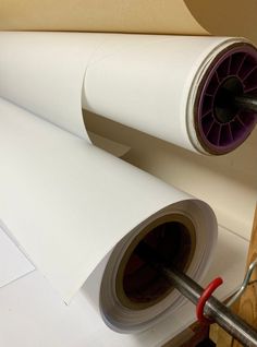 two rolls of white paper sitting next to each other