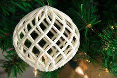 a white ornament hanging from a christmas tree