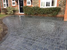 a brick driveway in front of a house