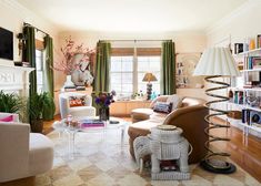 a living room filled with furniture and a fire place in the middle of a room