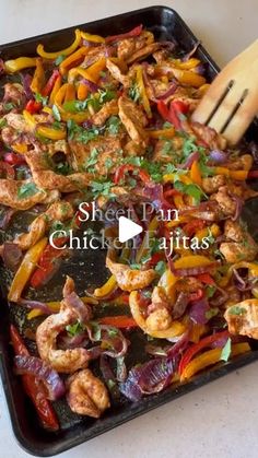 chicken fajitas with peppers and onions on a pan