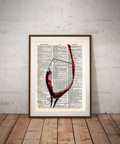 an old book page with a martini glass in it on a wooden table next to a brick wall